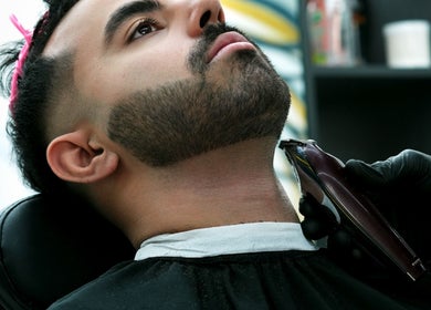 Expert barber at Dream Fade Gents Salon in Dubai, Dubai, AE giving a precise beard trim.