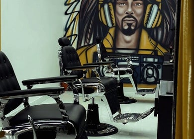 Stylish barber chairs in Dream Fade Barbershop, Dubai, Dubai, AE with unique wall art backdrop.