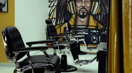 Stylish barber chairs in Dream Fade Barbershop, Dubai, Dubai, AE with unique wall art backdrop.