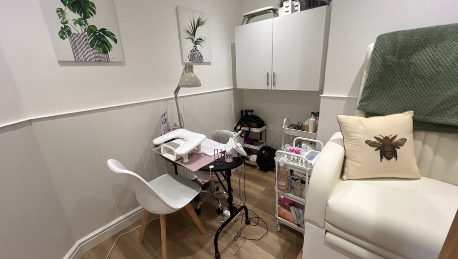Cozy nail station at Blooms Beauty Room, Burgess Hill, England, GB with decor and cushioned seating.