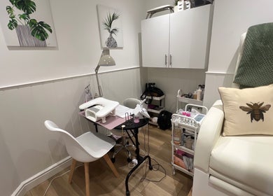 Cozy nail station at Blooms Beauty Room, Burgess Hill, England, GB with decor and cushioned seating.