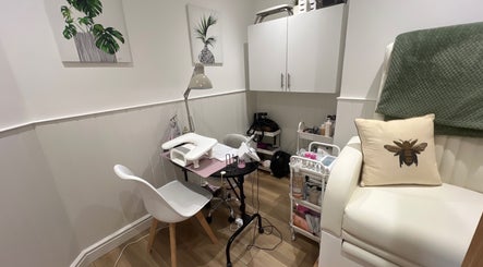 Cozy nail station at Blooms Beauty Room, Burgess Hill, England, GB with decor and cushioned seating.
