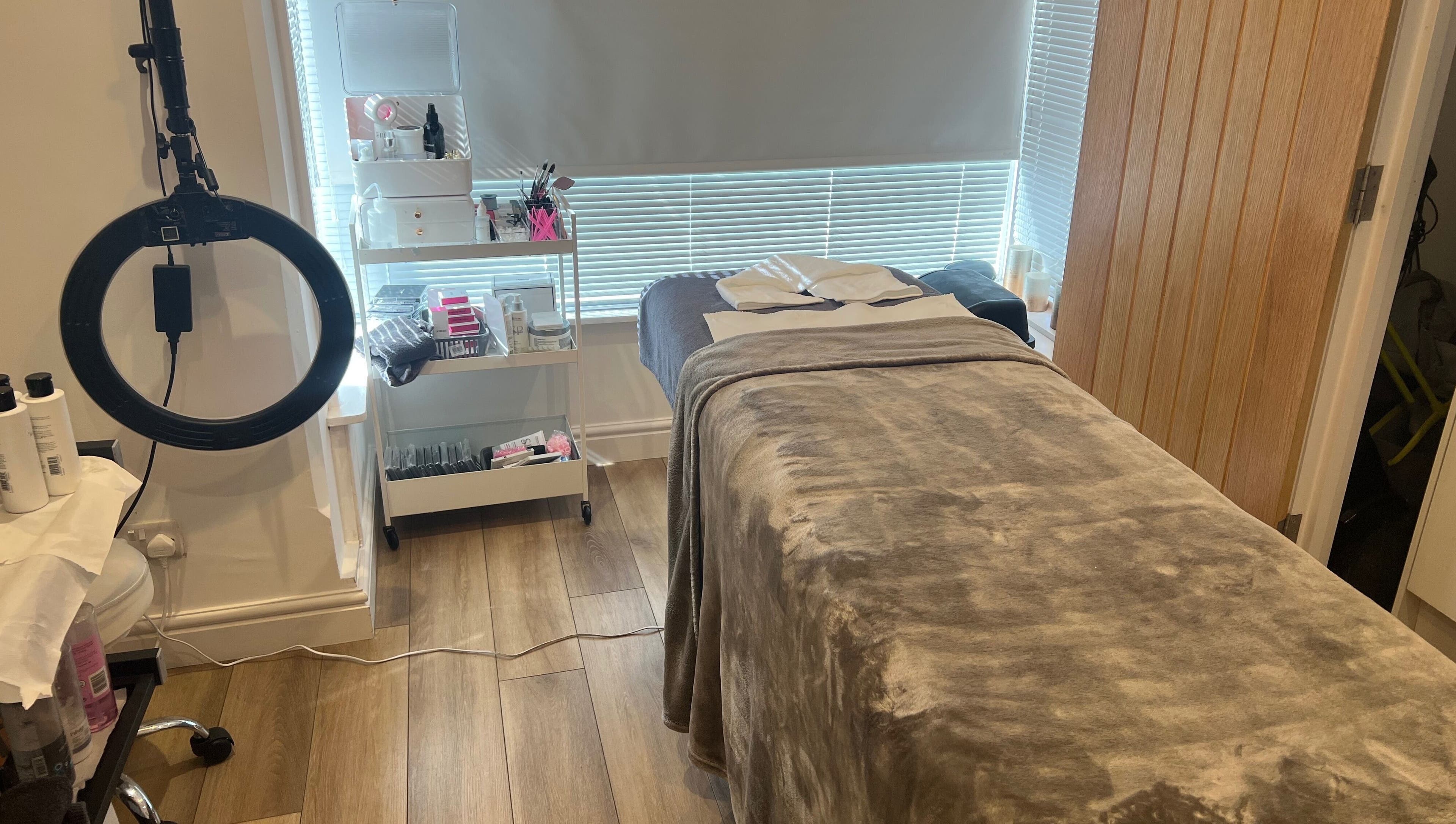 Tranquil treatment room at Blooms Beauty Room, Burgess Hill, England, showcasing spa bed and beauty tools.