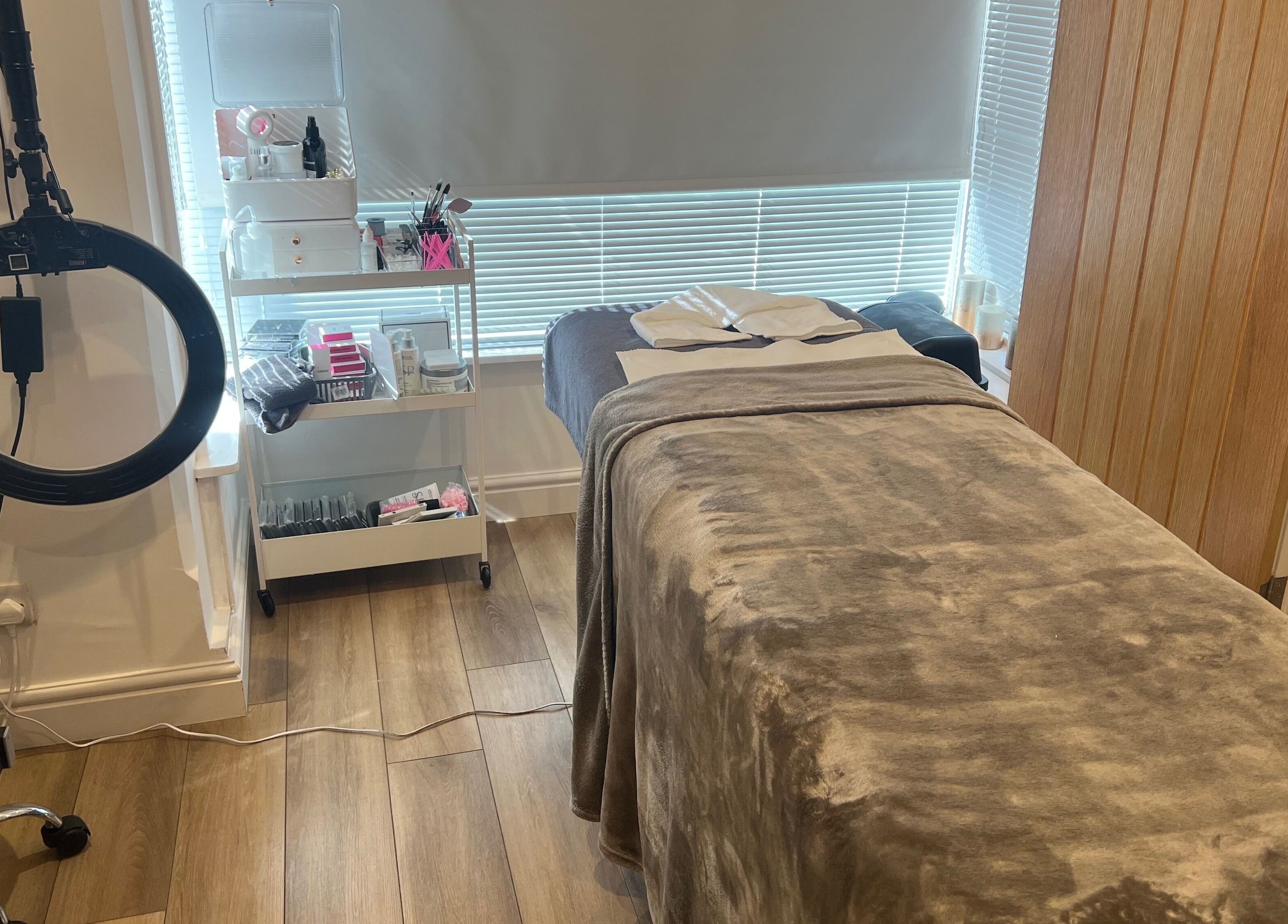 Tranquil treatment room at Blooms Beauty Room, Burgess Hill, England, showcasing spa bed and beauty tools.