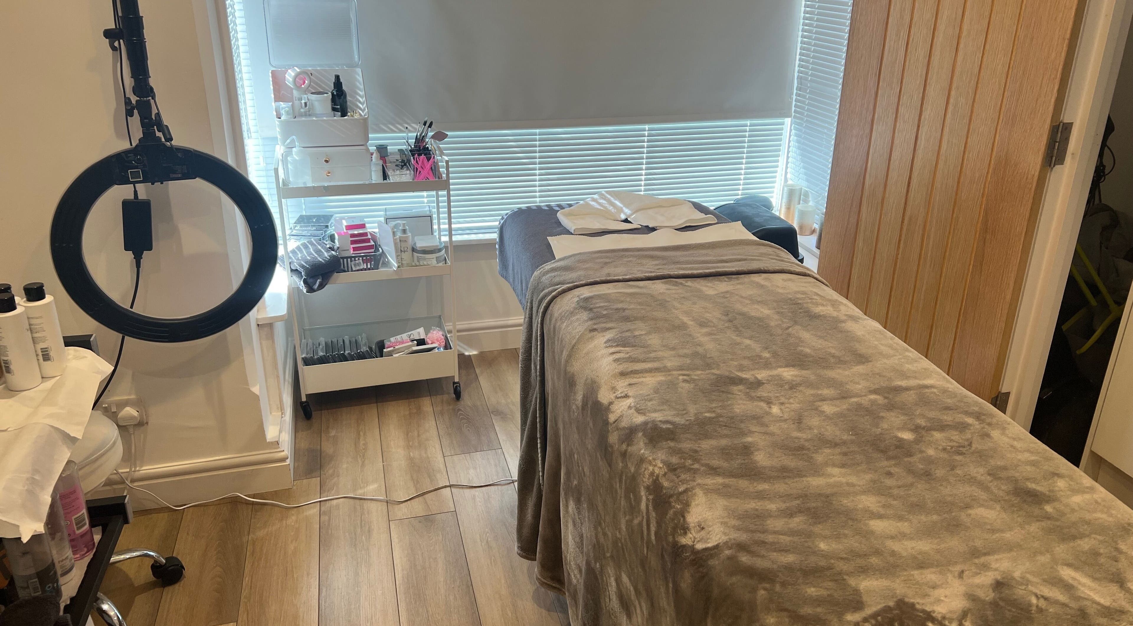 Tranquil treatment room at Blooms Beauty Room, Burgess Hill, England, showcasing spa bed and beauty tools.