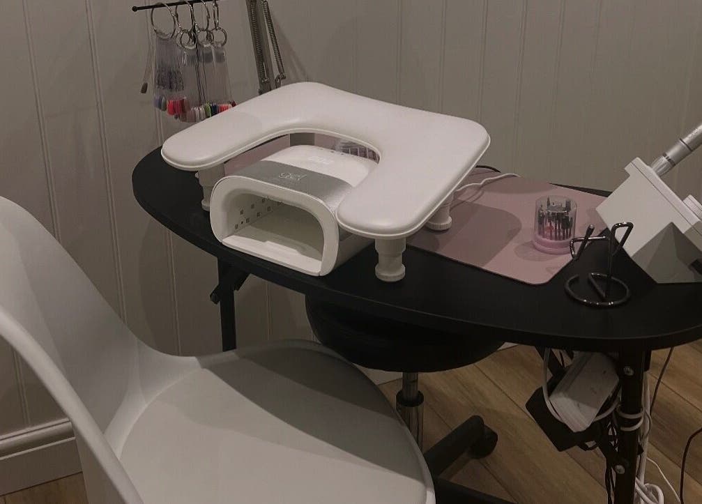 Nail station at Blooms Beauty Room in Burgess Hill, England, GB, featuring modern equipment and a sleek design.
