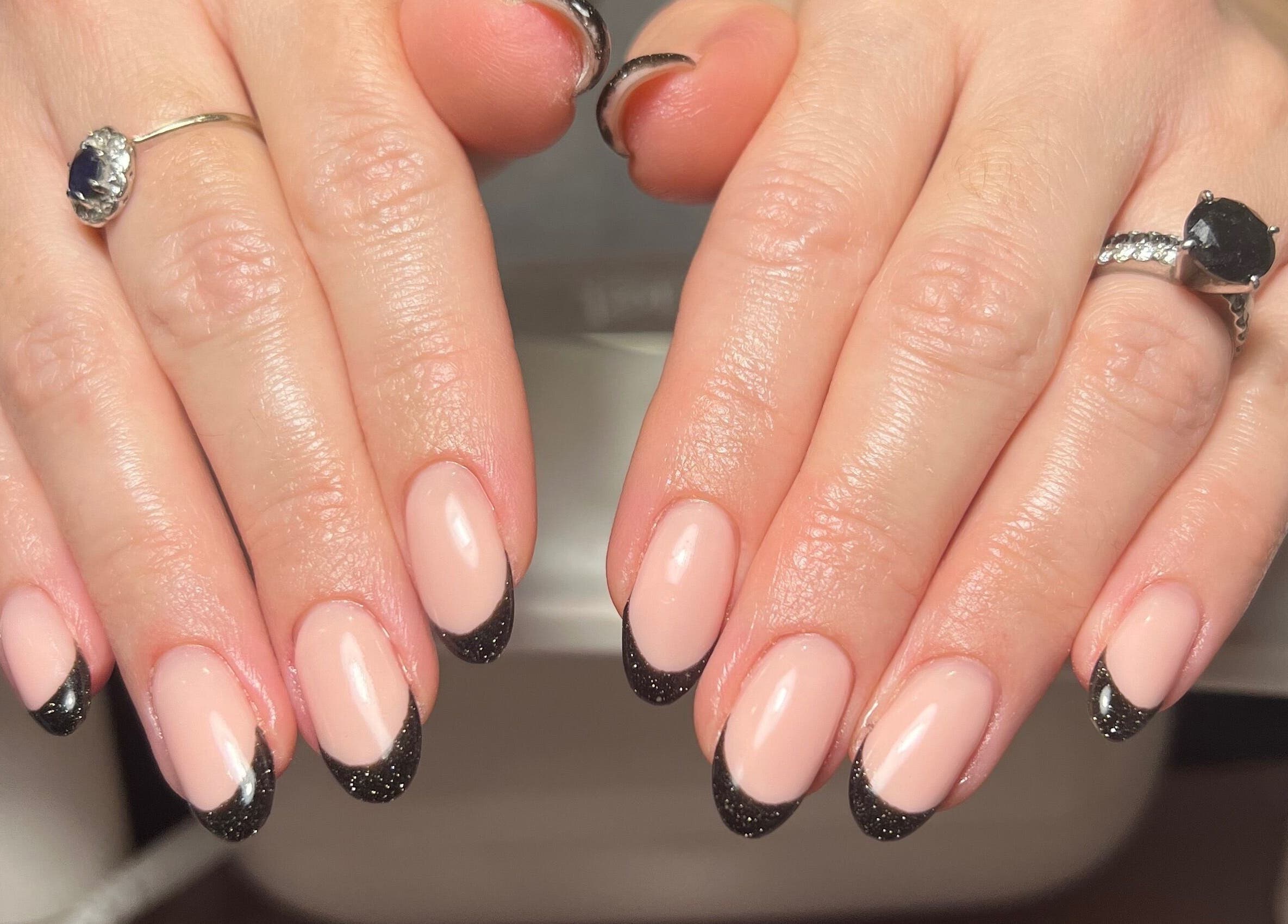 French manicure at Blooms Beauty Room in Burgess Hill, England, GB. Glossy black tips on a nude base.