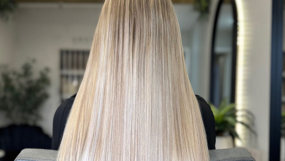 Sleek, long blonde hair styled at Adore Hair Extensions, Bristol, England, GB.