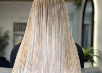 Sleek, long blonde hair styled at Adore Hair Extensions, Bristol, England, GB.