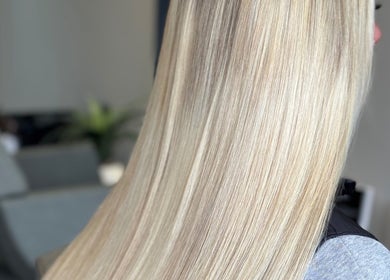 Silky blonde hair at Adore Hair Extensions in Bristol, England, GB, showcasing expert styling and smooth finish.