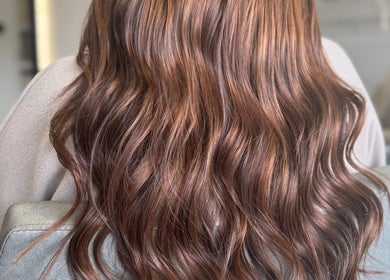 Lustrous brown waves styled at Adore Hair Extensions in Bristol, England, GB, capturing elegance and sheen.