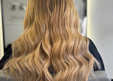Long, wavy blonde hair styled at Adore Hair Extensions, Bristol, England, GB salon.