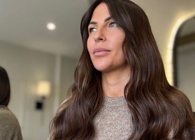 Woman with long wavy hair in Adore Hair Extensions, Bristol, England, GB.