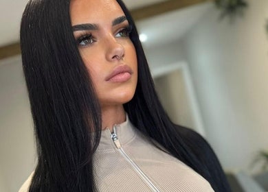 Woman with sleek black hair at Adore Hair Extensions, Bristol, England, GB.
