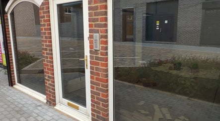 Street view of SK & Co Salon's elegant entrance in Hatfield, England, GB, showcasing a contemporary design.