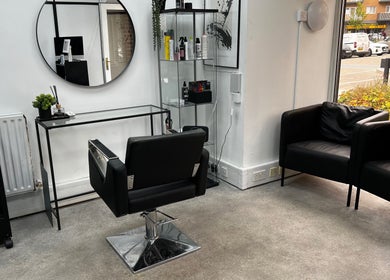 Sleek salon chair and mirror at SK & Co Salon, Hatfield, England, GB, showcasing modern design.