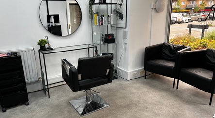 Sleek salon chair and mirror at SK & Co Salon, Hatfield, England, GB, showcasing modern design.