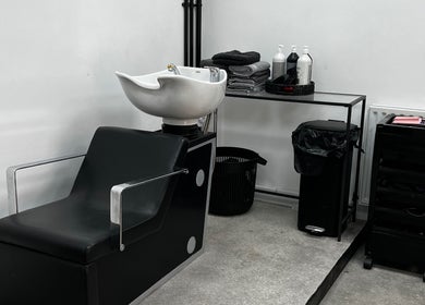 Modern salon wash station at SK & Co Salon in Hatfield, England, GB, featuring elegant black and white decor.