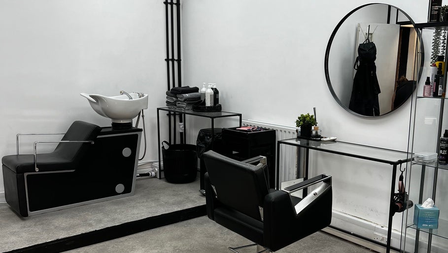 Chic salon interior at SK & Co Salon, Hatfield, England, GB featuring modern styling chairs and mirrors.