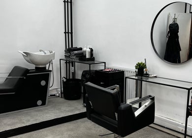 Chic salon interior at SK & Co Salon, Hatfield, England, GB featuring modern styling chairs and mirrors.