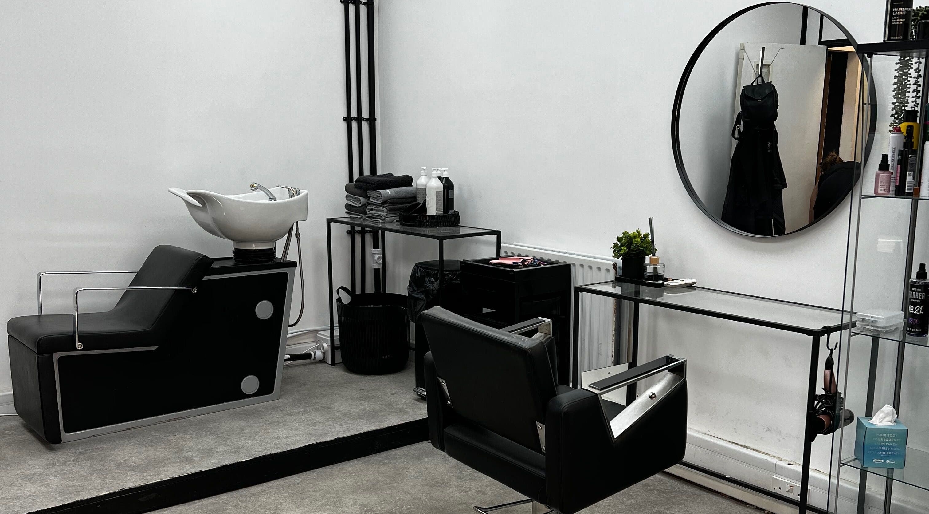 Chic salon interior at SK & Co Salon, Hatfield, England, GB featuring modern styling chairs and mirrors.