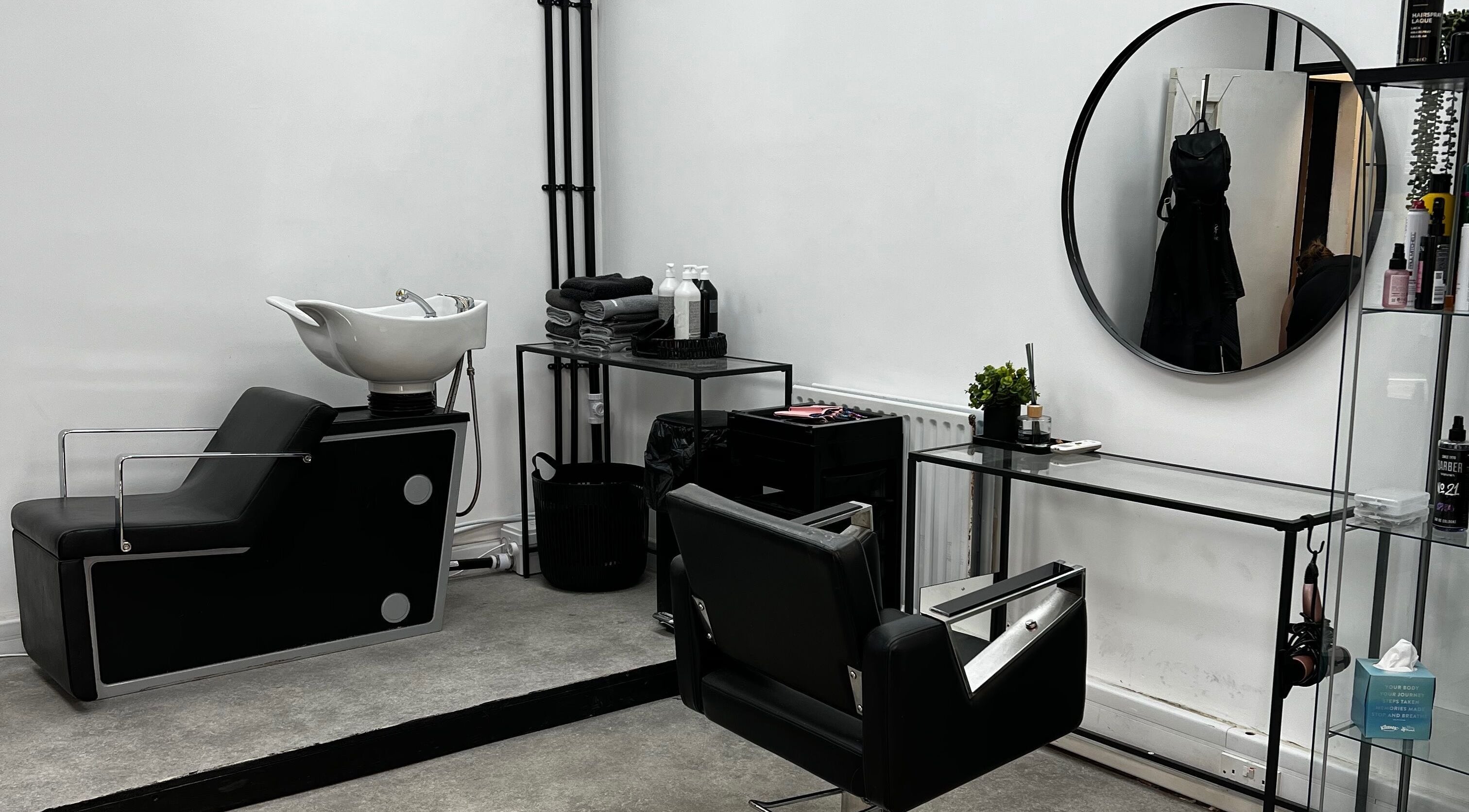 Chic salon interior at SK & Co Salon, Hatfield, England, GB featuring modern styling chairs and mirrors.