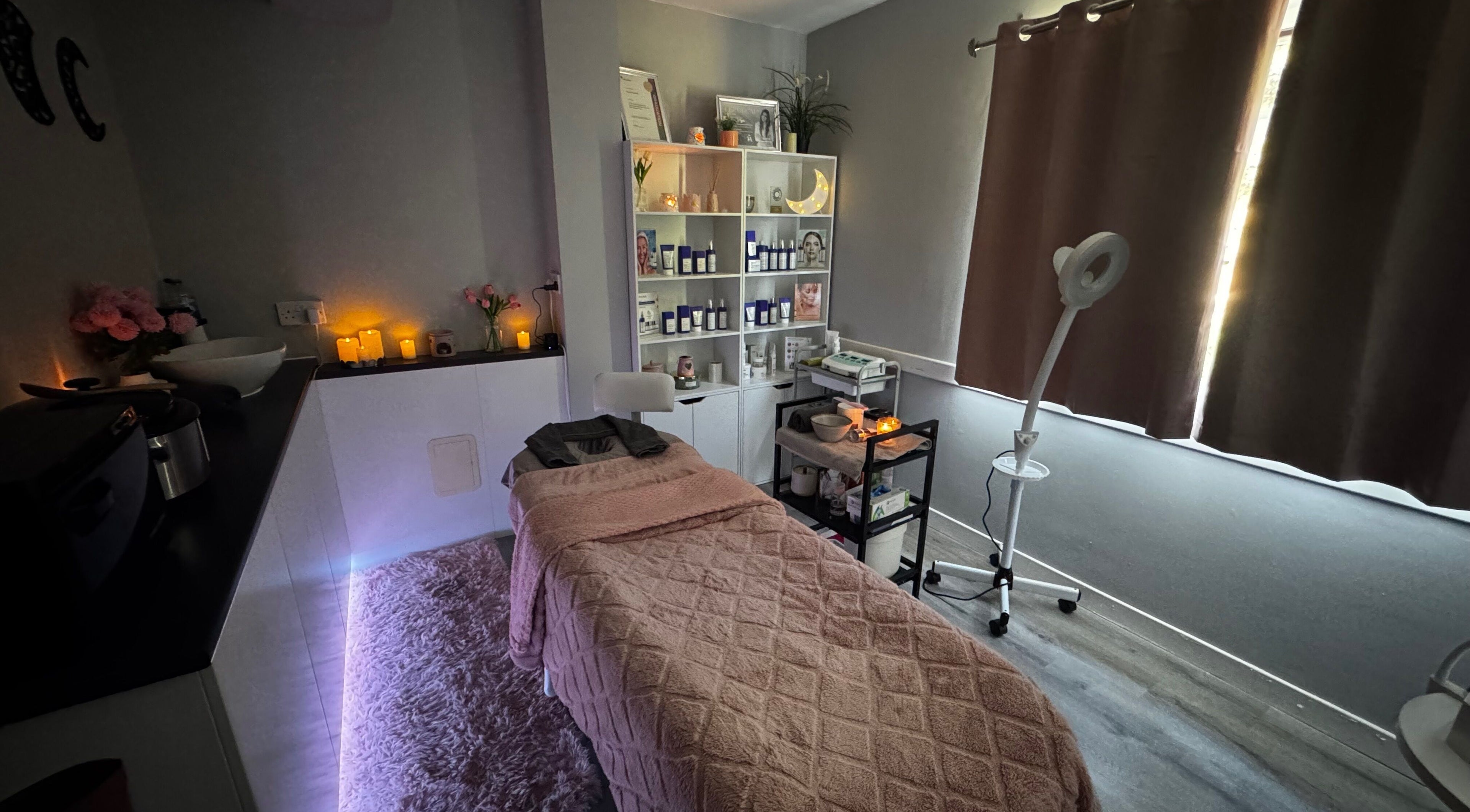 Moonlight Beauty's tranquil treatment room in Rosyth, Scotland, GB with cozy decor and glowing candles.