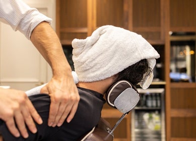Gentle massage at The Barbershop On Mill Street in London, England, GB with warm towel wrap.