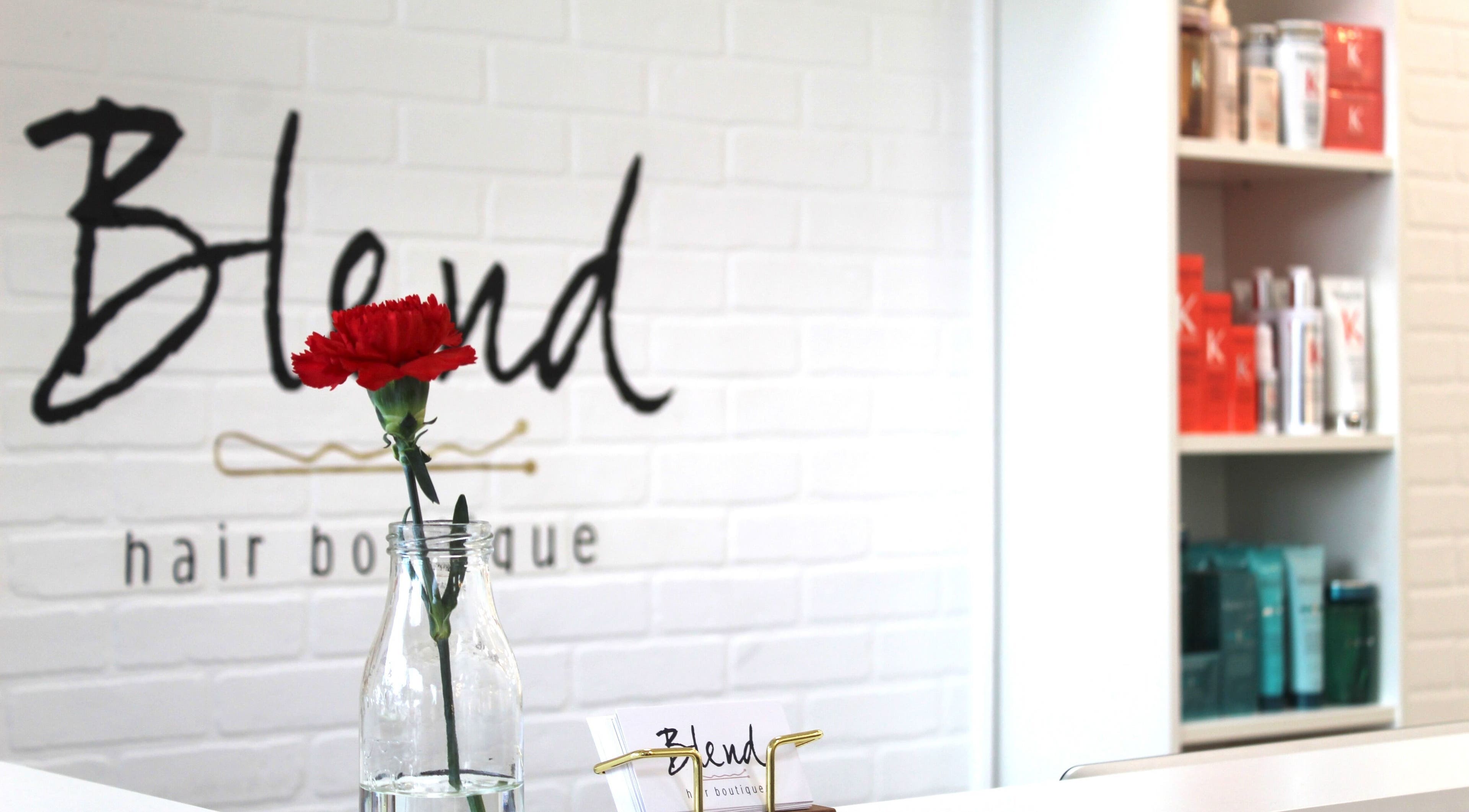 Elegant interior of Blend Hair Boutique in Plantation, Florida, US with a red flower centerpiece.