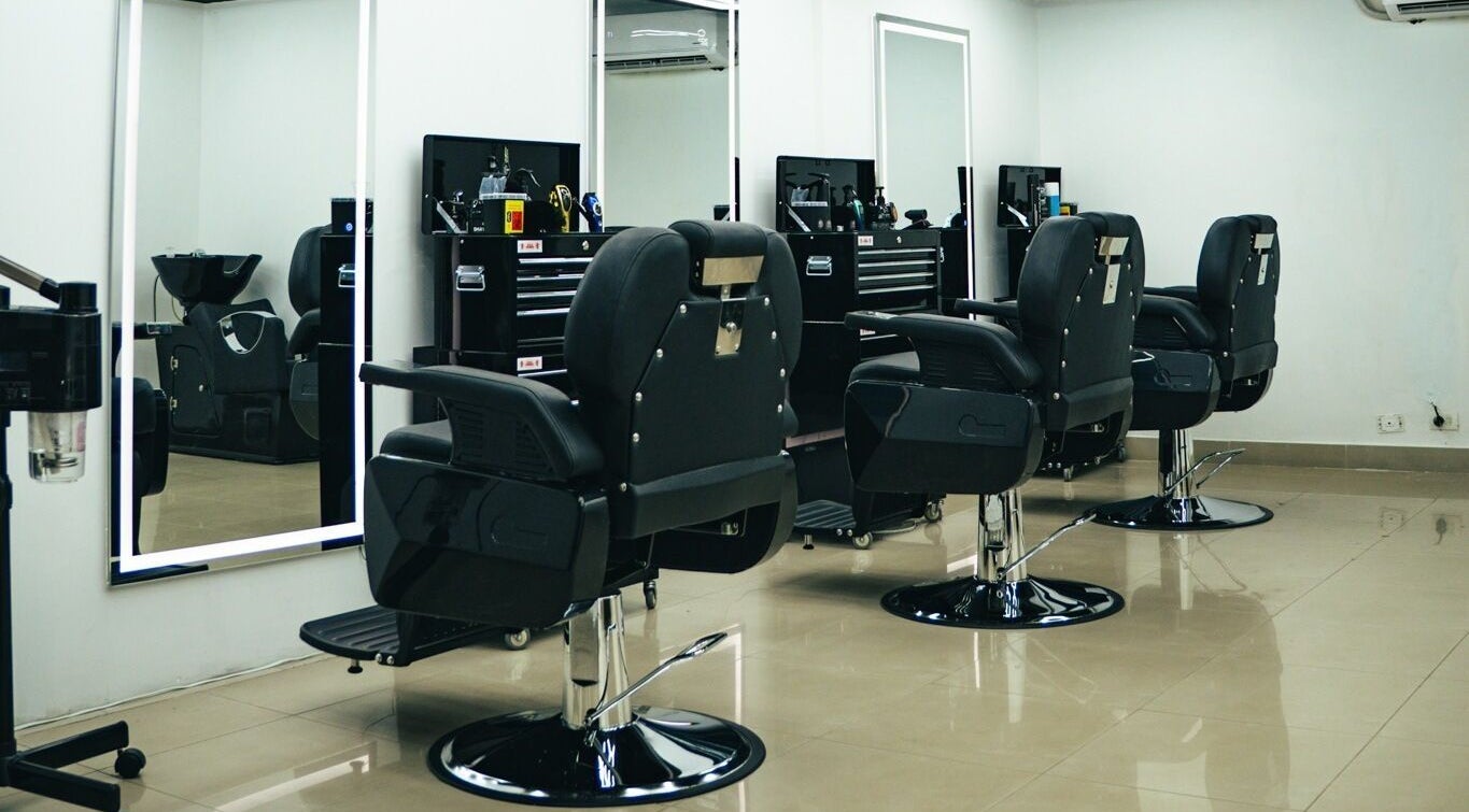 Interiores modernos de Bass Barberia en Cali, Valle Del Cauca, CO con elegantes sillas y espejos.