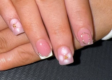 Elegant pink and white nail art at Bee’s Beauty, Coventry, England, GB, showcasing intricate gold details.