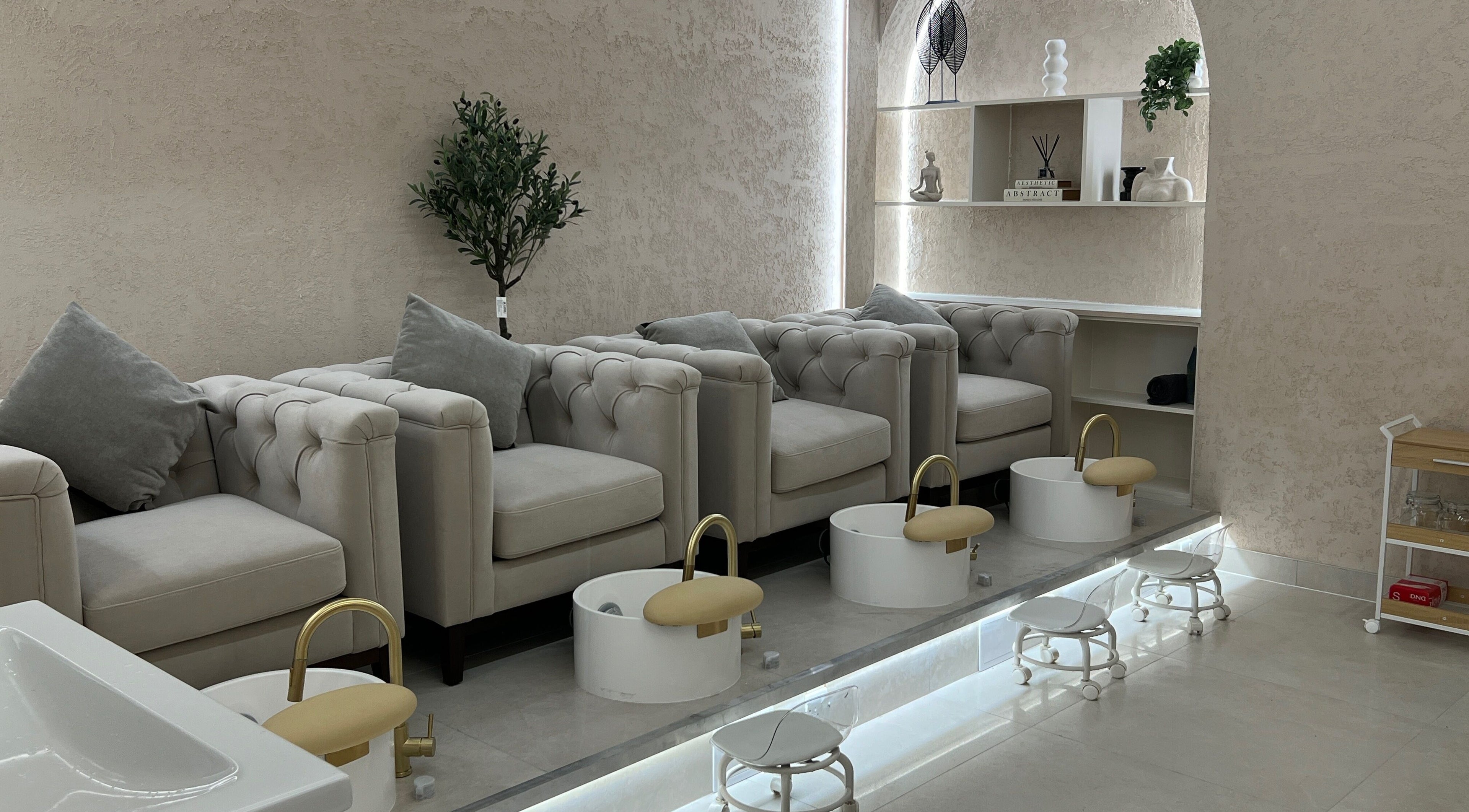 Luxurious pedicure lounge at Amore Beam Park, Rainham, England, GB with plush seating and modern decor.