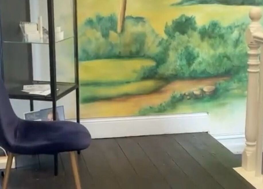 Cozy seating with artistic wall at LASHED EYELASH EXTENSIONS Albert Park, Victoria, AU.