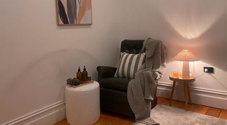 Cozy corner with armchair at Yarraville Massage, Melbourne, Victoria, AU, enhancing relaxation and comfort.