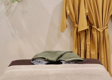 Calming massage room at Yarraville Massage in Melbourne, Victoria, AU, featuring robes and a massage table.