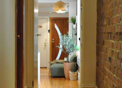 Hallway at Yarraville Massage with cozy seating and plants in Melbourne, Victoria, AU.