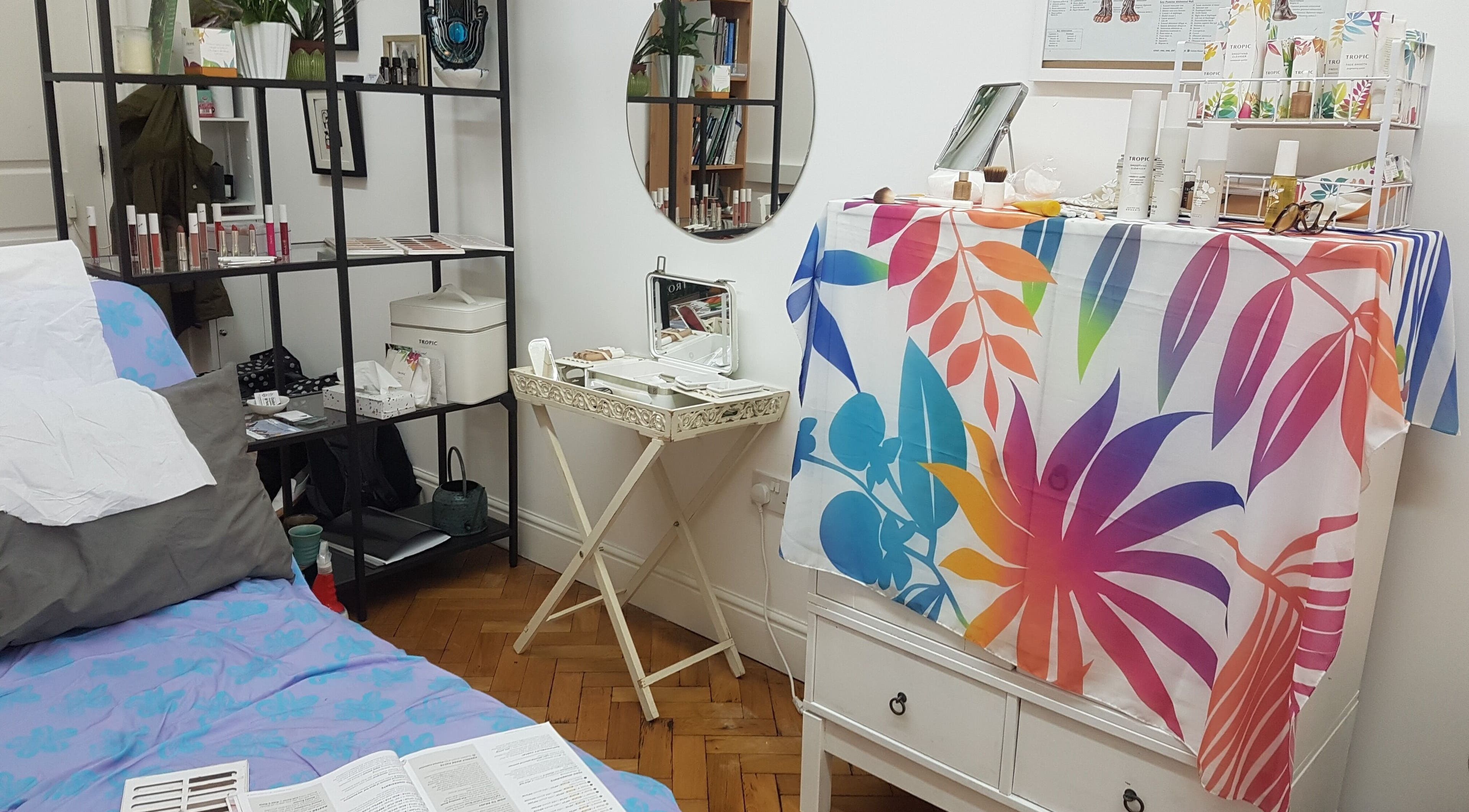 Calm therapy space at Ouseburn Massage Therapy, Newcastle upon Tyne, England, GB with colorful decor and mirrors.