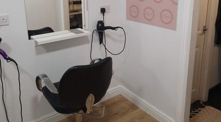 Modern styling station at Hannah Hairdressing in Penketh, England, GB, featuring a sleek chair and mirror.