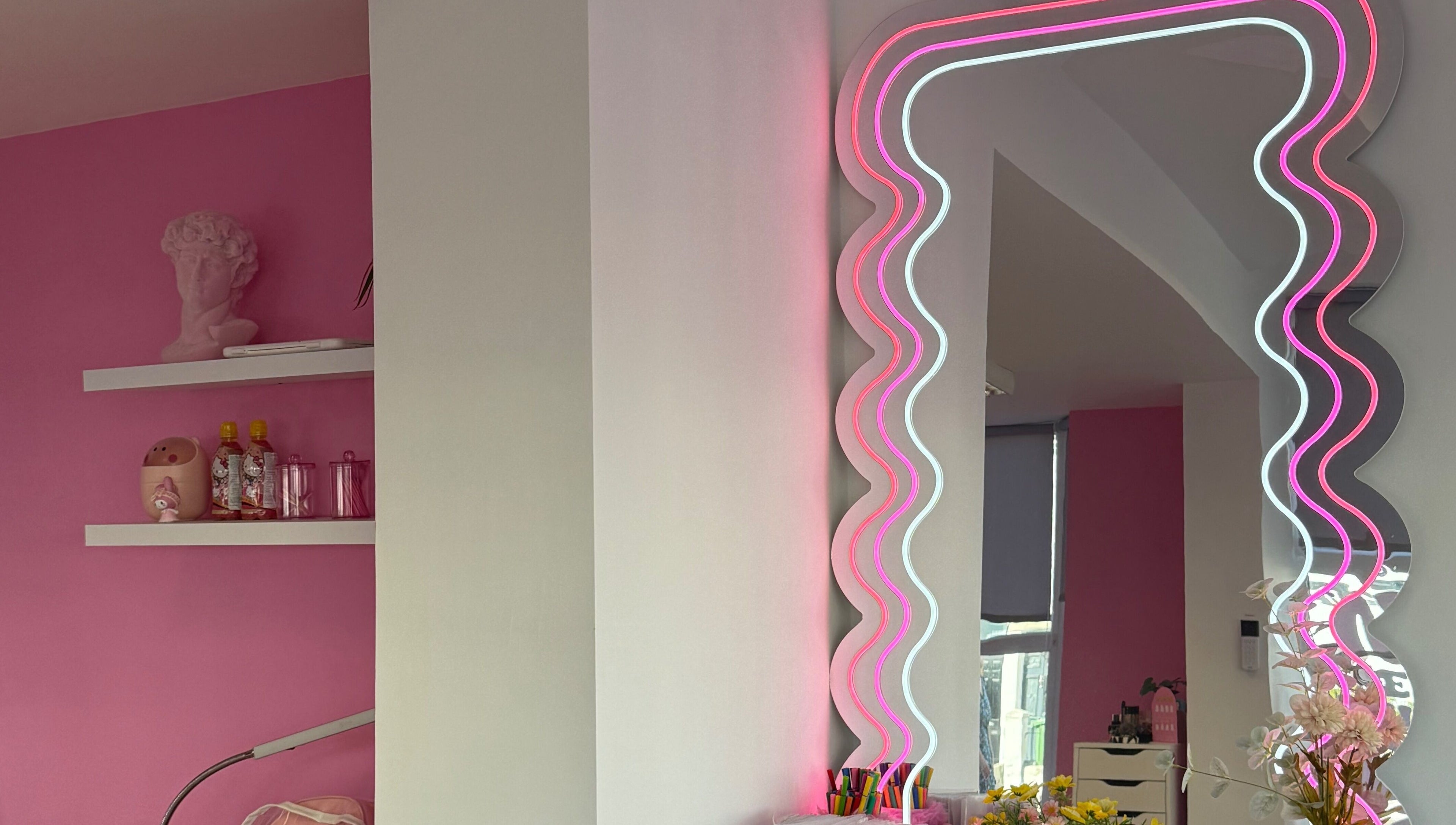 Modern neon mirror at Nails With Soph, Eastbourne, England, GB, enhancing the vibrant salon decor.