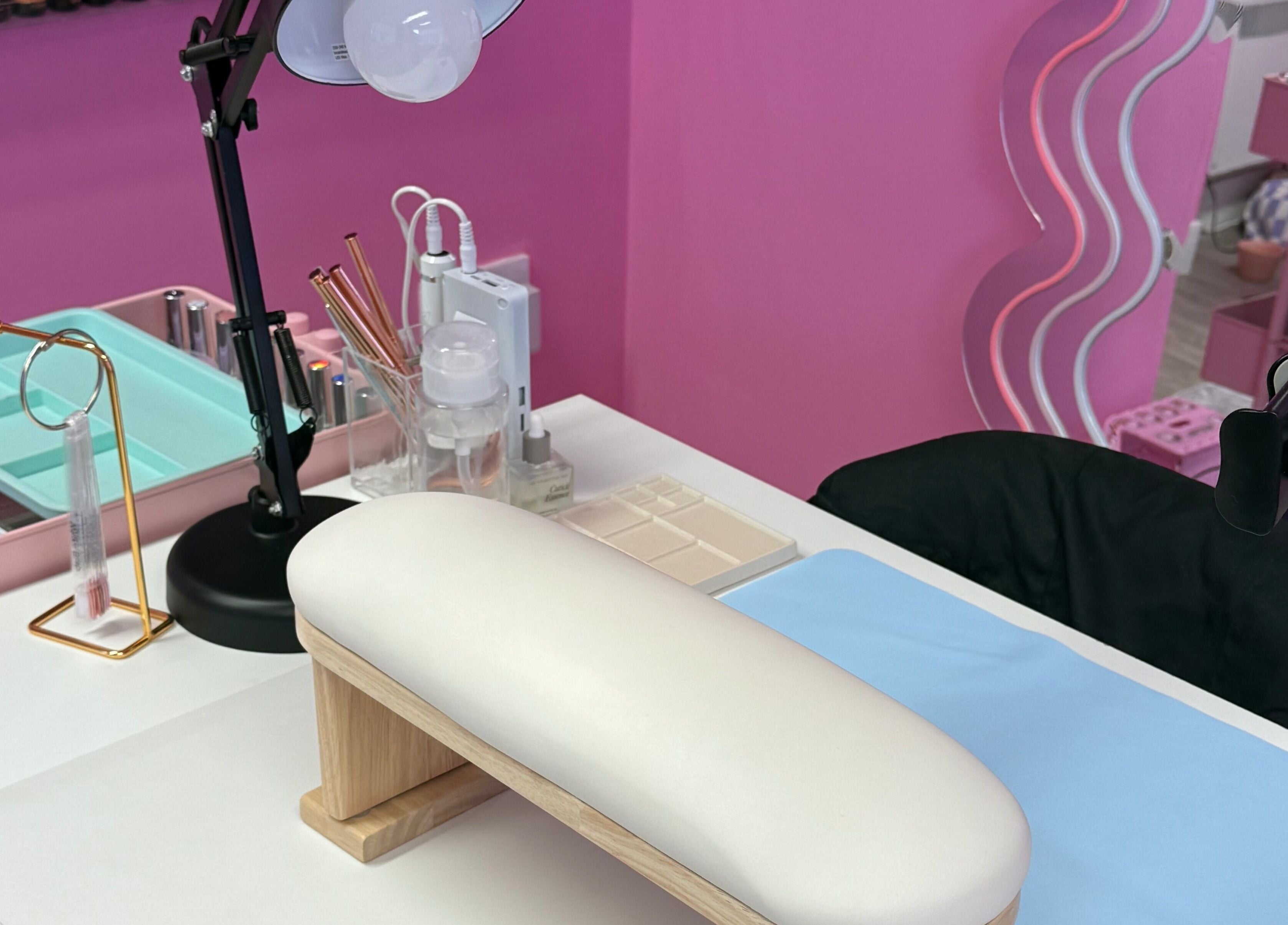 Manicure station at Nails With Soph in Eastbourne, England, GB, featuring a chic pink decor.