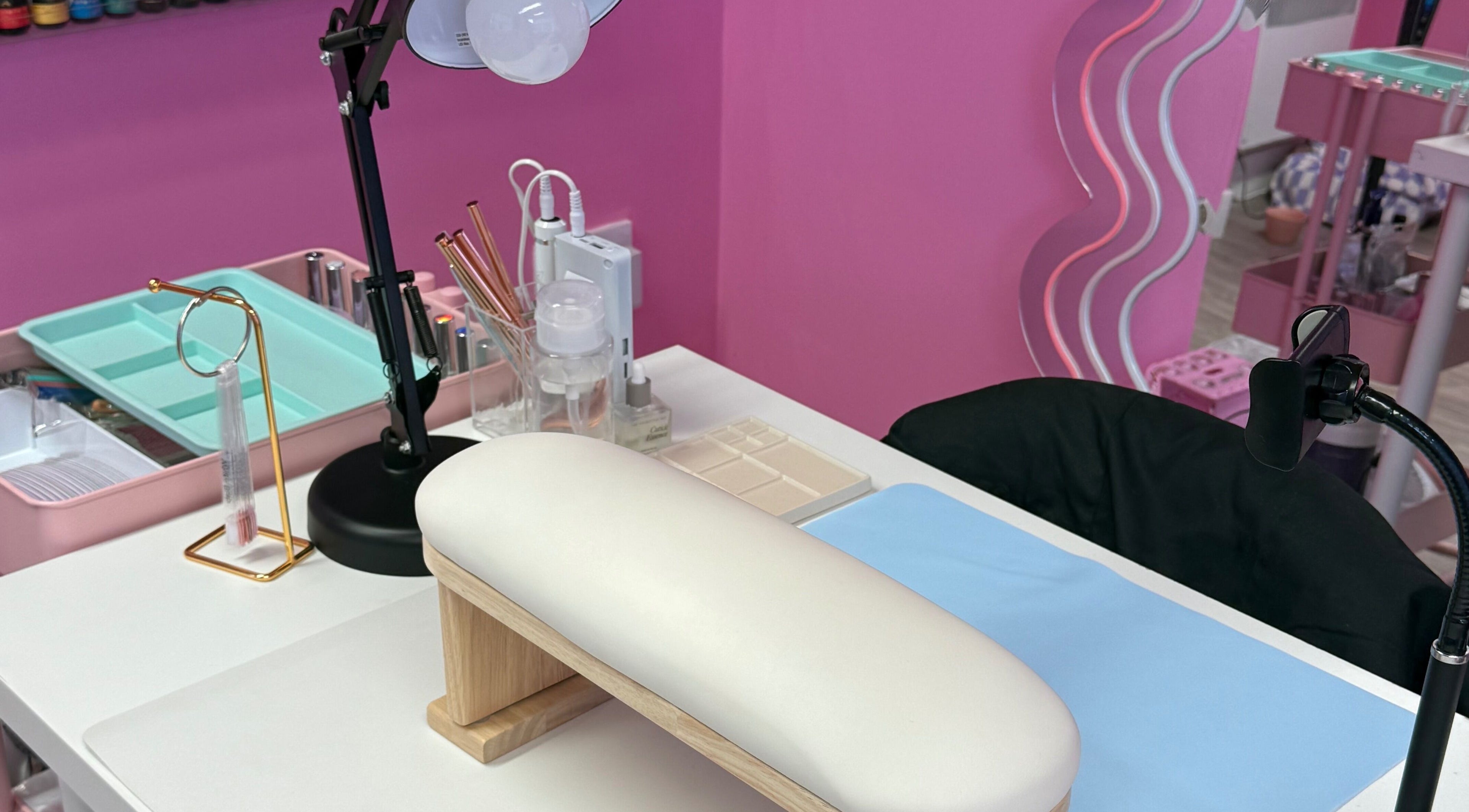 Manicure station at Nails With Soph in Eastbourne, England, GB, featuring a chic pink decor.