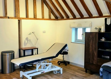 Cozy treatment room at Georgina Holly Aesthetics, Betchworth, England, GB, showcasing a rustic, inviting setting.