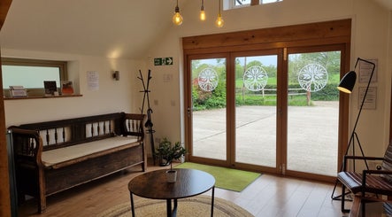 Charming lounge at Georgina Holly Aesthetics, Betchworth, England, featuring cozy seating and natural light.
