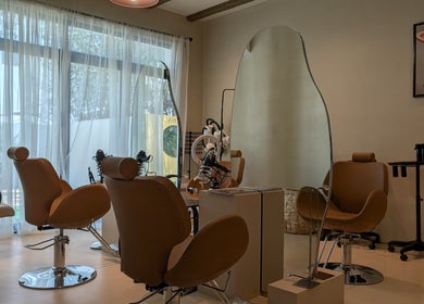 Stylish interior of Absa Ladies Beauty Salon, Dubai, Dubai, AE, featuring modern salon chairs and mirrors.