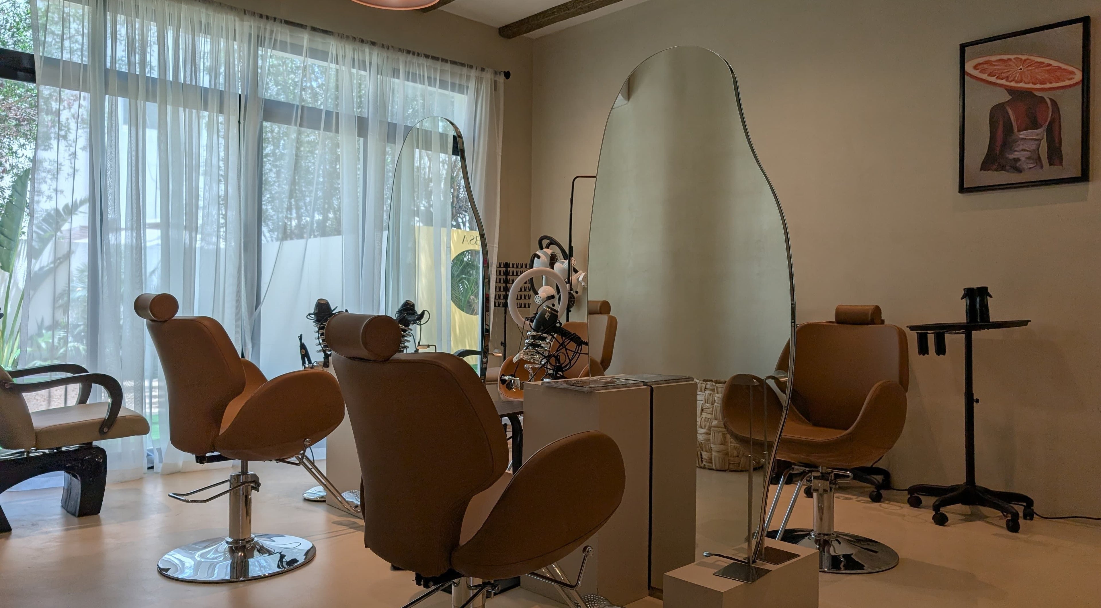 Stylish interior of Absa Ladies Beauty Salon, Dubai, Dubai, AE, featuring modern salon chairs and mirrors.
