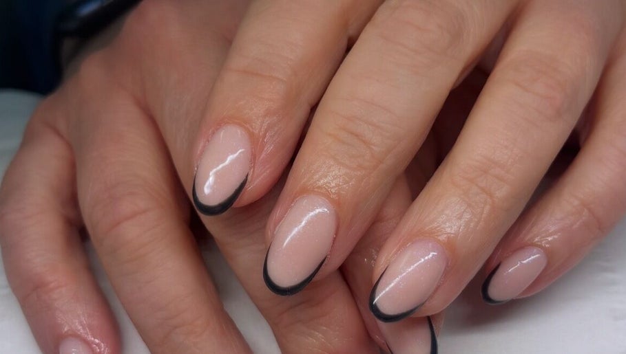 Elegant French manicure with black tips at Ems Beauty, Stockport, England, GB. Perfectly groomed for a refined look.