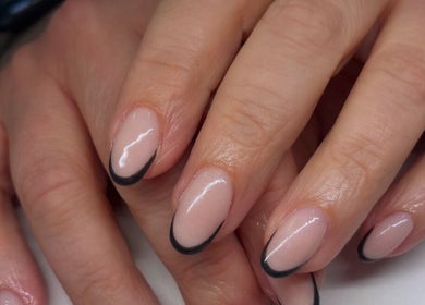 Elegant French manicure with black tips at Ems Beauty, Stockport, England, GB. Perfectly groomed for a refined look.