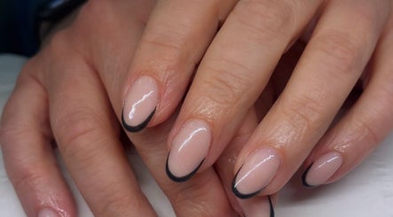 Elegant French manicure with black tips at Ems Beauty, Stockport, England, GB. Perfectly groomed for a refined look.