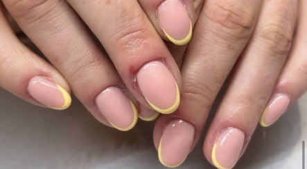 Stylish yellow-tipped manicure at Ems Beauty, Stockport, England, GB, showcasing expert nail artistry.
