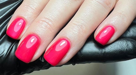 Bright red manicure at The Snug Room, Ravenfield, England, GB showing shiny, well-groomed nails.